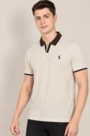 Model wearing an oatmeal short-sleeve polo with dark contrast collar and cuffs, front view