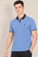 Model wearing a heather blue short-sleeve polo with navy contrast collar and cuffs, front view