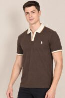 Model wearing a dark brown short-sleeve polo with cream contrast collar and cuffs, front view